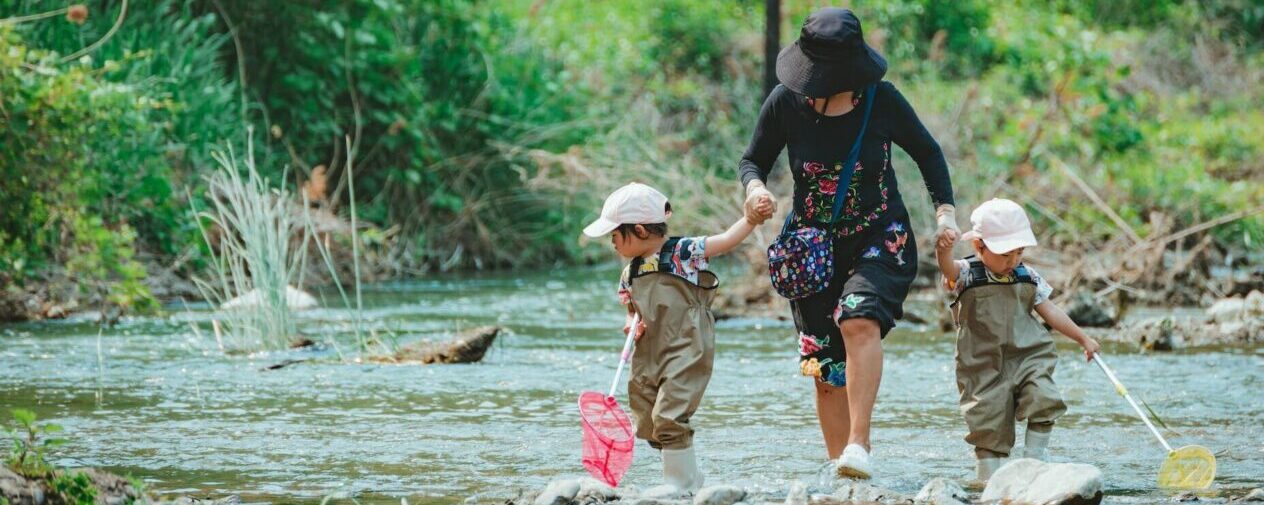 mother and children walking on a river